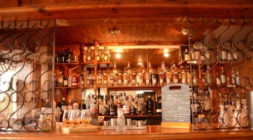 a bar filled with lots of bottles of alcohol at Creag Mhor Lodge in Onich