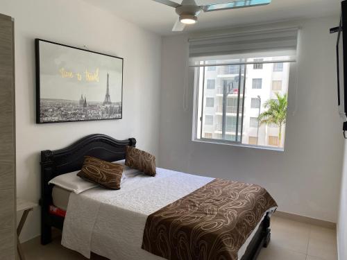 a bedroom with a bed and a window at Aqualina Orange Apartamento Piso 3 Vista a Piscina 3 Habitaciones in Girardot