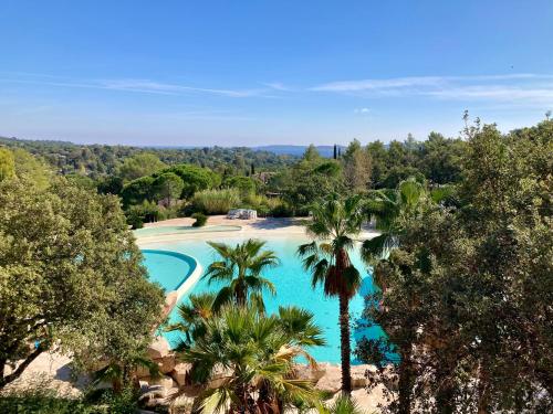 una vista aérea de una piscina con palmeras en Les Restanques 3120 vue mer 3 chambres en Grimaud