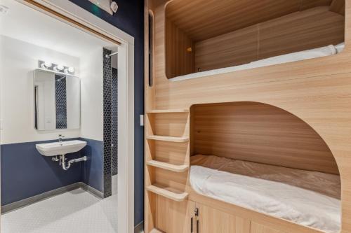 a small bathroom with a bunk bed and a sink at Meco Hotel in Boston