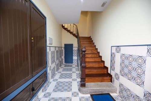 a hallway with stairs and a blue door at EREA apartamentos turísticos in Monforte de Lemos