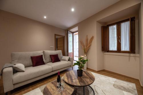 ein Wohnzimmer mit einem Sofa und einem Tisch in der Unterkunft EREA in Monforte de Lemos