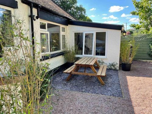 a picnic table in front of a house at Edge view, outdoor adventure focused cottage, sleeps 8 in Bamford