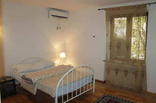 um quarto com uma cama e uma janela em Bueno Guest hause em Yerevan