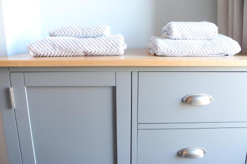 two towels are sitting on top of a table at Coastal Retreat in Fife