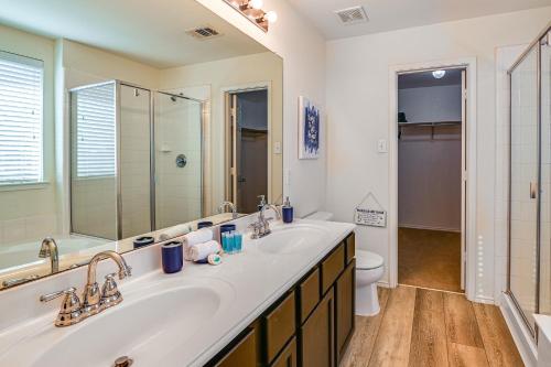 a bathroom with a sink and a toilet and a mirror at McKinney Home with Smart TV 10 Mi to Historic Dwtn! in Frisco