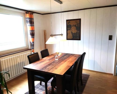 a dining room with a wooden table and chairs at Ferienhaus Loreleytal in Boppard