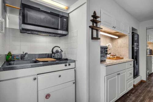 a kitchen with a sink and a microwave at Secret Stairs Studio #1 in Los Angeles