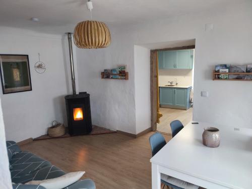 a living room with a wood stove in a room at Vivenda Montanha - Relax in Nature in Alcaria