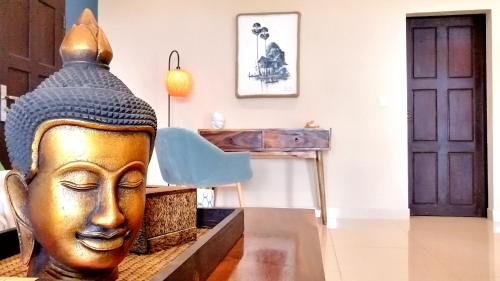 a statue of a head in a room with a desk at Villa 'The Blue House' - Qbungalows in Kep