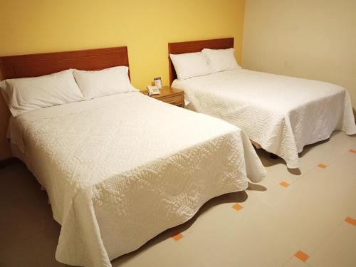 two beds sitting next to each other in a room at SAN ANDRES in Ipiales