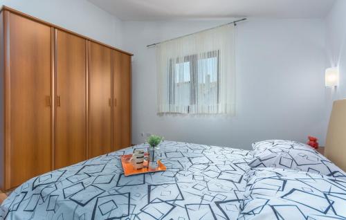 a bedroom with a large bed and a cabinet at Apartment Valeria Vabriga in Vabriga