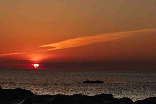 a sunset over the ocean with the sun setting at Secluded Luxury Pod with Hot Tub in Launceston