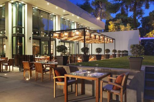 a restaurant with tables and chairs in front of a building at Life Gallery Athens in Athens