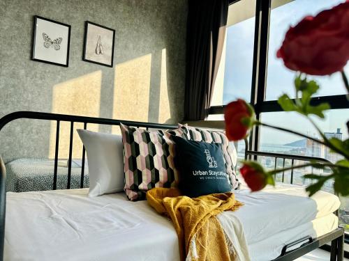 a bed with pillows in a room with a window at New Urban Suite Majestics 3BR Homestay at Georgetown BY URBAN STAYCATION HENG LOD in Jelutong