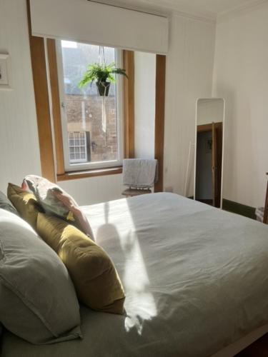 a bedroom with a large bed and a window at East Nook in Anstruther