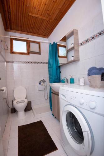 a bathroom with a washing machine in a bathroom at Casa Chrysi in Mesimvría
