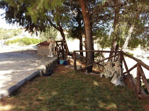 a group of stuffed animals sitting next to a fence at La Mortella Agriturismo in Rotondella