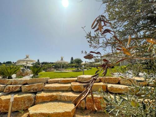 a set of stone steps in a garden at Splendida Villa NATURE-APPARTAMENTO MELOGRANO a SCOPELLO-ZINGARO vista sul mare in Scopello
