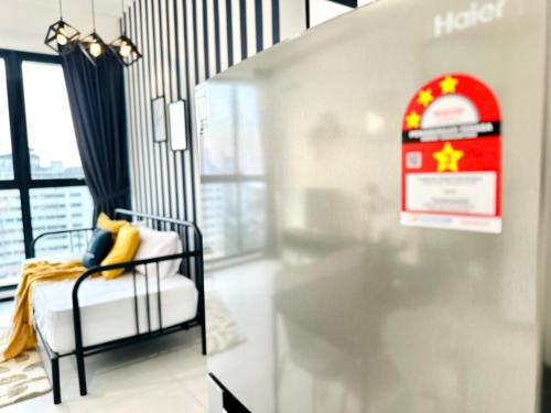 a bedroom with a hotel sign and a bed with yellow pillows at New Urban Suite Majestics 3BR Homestay at Georgetown BY URBAN STAYCATION HENG LOD in Jelutong