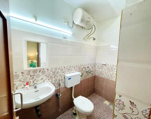 a bathroom with a toilet and a sink at Luxurious 2 BHK Villa AniRah Homes 2 minutes to beach in Colva