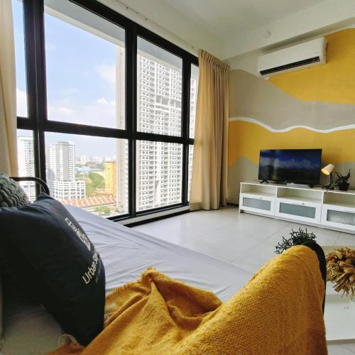 a living room with a couch and a large window at New Urban Suite Majestics 3BR Homestay at Georgetown BY URBAN STAYCATION HENG LOD in Jelutong