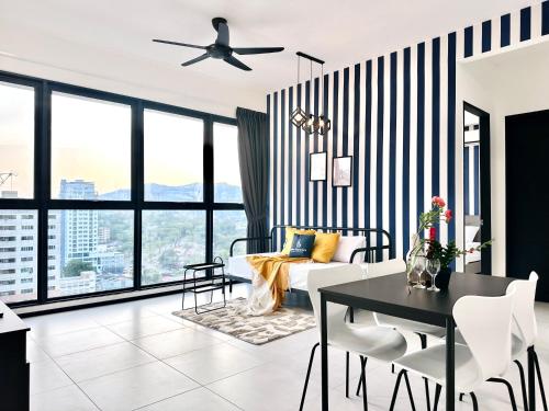 a living room with a black and white striped wall at New Urban Suite Majestics 3BR Homestay at Georgetown BY URBAN STAYCATION HENG LOD in Jelutong