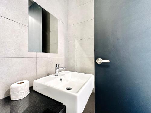 a white bathroom with a sink and a mirror at New Urban Suite Majestics 3BR Homestay at Georgetown BY URBAN STAYCATION HENG LOD in Jelutong