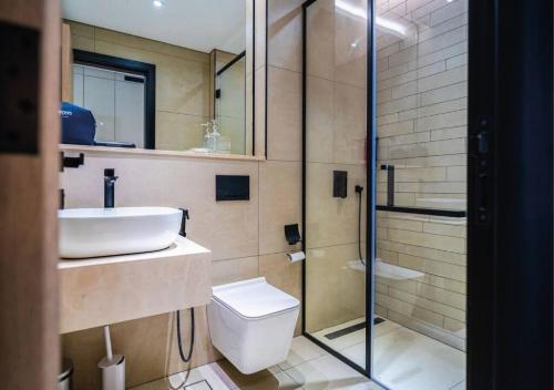 a bathroom with a sink and a toilet and a shower at OMO! Insane Deal! Studio near Me'aisem City Center in Dubai