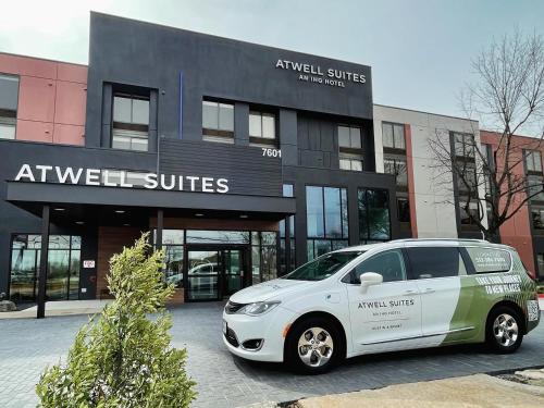 a white car parked in front of a building at Atwell Suites Austin Airport by IHG in Austin