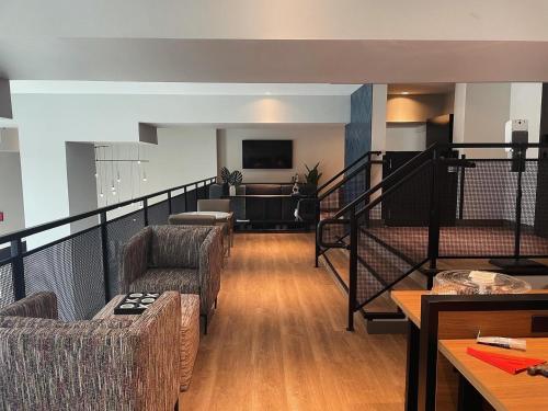 a living room with two chairs and a couch at Atwell Suites Austin Airport by IHG in Austin