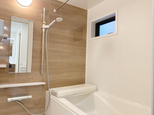 a bathroom with a shower and a sink and a tub at Shinjuku#ookubo#kabukicho#New built 3beds room,3 toilets, 2 shower rooms#新宿中心#大久保#歌舞伎#地铁站步行2分#新建公寓3层3卧室3卫生间2浴室1客厅#高速无限制网络#智能马桶#干湿分离103 in Tokyo