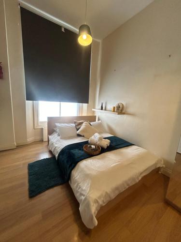 a bedroom with two beds and a large window at Comfy studio in London