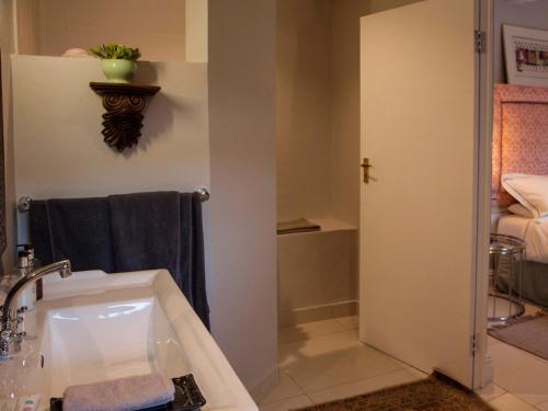 a bathroom with a tub and a sink at The Montagu Coach House in Montagu