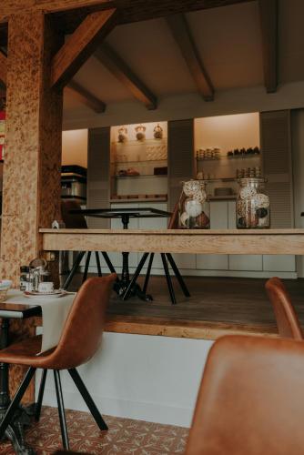 a dining room with a wooden table and chairs at Ouwe Schuure in Sluis