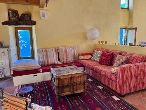 a living room with a couch and a table at Mas Daudé in Valleraugue