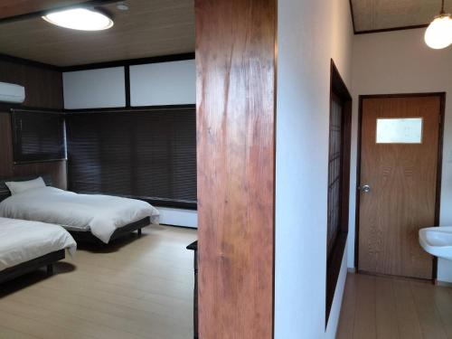 Postel nebo postele na pokoji v ubytování Guesthouse Sakichi