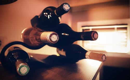 four bottles of wine sitting on top of a table at La Suite de l'Elixir in Argentré-du-Plessis