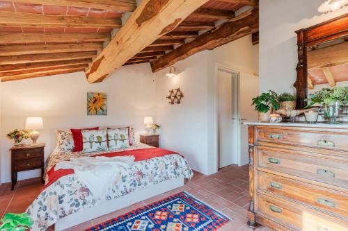 a bedroom with a large bed and wooden ceilings at Casa Noscali al Borghetto in Collodi