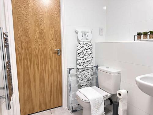 a bathroom with a toilet and a sink at Queens House City Centre Apartments in Sheffield