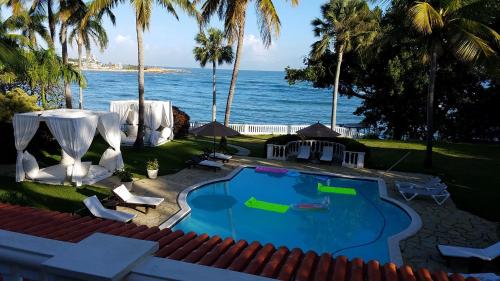 サン・フェリペ・デ・プエルト・プラタにある6 Bedroom Villas at Luxury All-Inclusive Resortの海の景色を望むスイミングプール