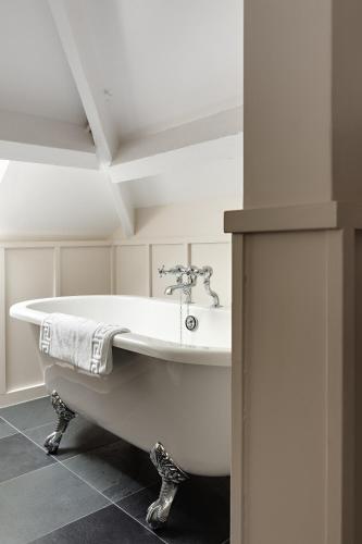 a white bath tub in a room with a ceiling at Chestnut Villa in Grasmere