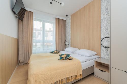 Un pat sau paturi într-o cameră la Apartamenty NCNK Trimare Sztutowo