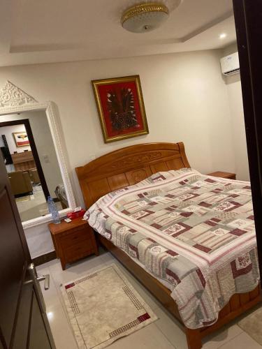 a small bedroom with a bed and a mirror at Harmonie ville in Dakar