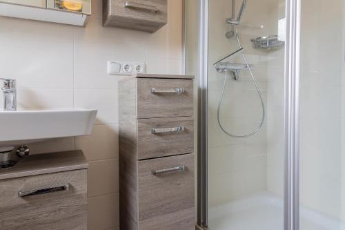 een badkamer met een douche en een wastafel bij Haus Harle 50203 Ferienhaus Harle 1 in Harlesiel