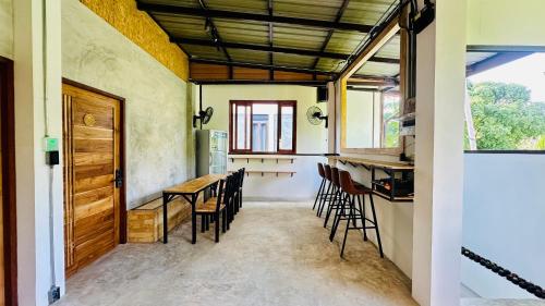 eine Küche und ein Esszimmer mit einem Tisch und Stühlen in der Unterkunft Koh Tao Silver Na’s Hostel in Ko Tao