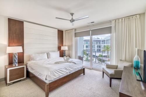a bedroom with a large bed and a window at Texas Two Step in Rosemary Beach
