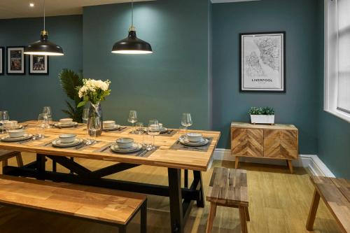 une salle à manger avec une table en bois et des fleurs. dans l'établissement Host & Stay - The Georgian Quarters at Falkner Street, à Liverpool