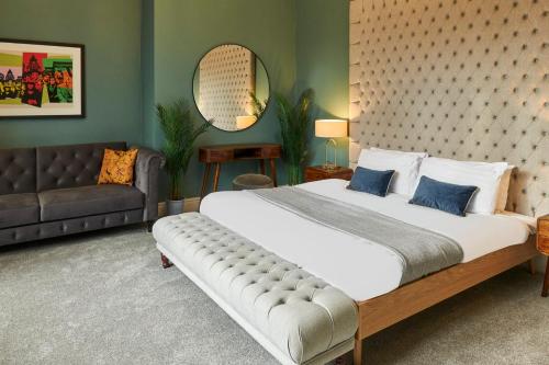 a bedroom with a large bed and a couch at Host & Stay - The Georgian Quarters at Falkner Street in Liverpool