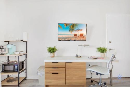 an office with a white desk and a picture of a beach at Spectacular View with Balcony, Pool, Near Beach in Hallandale Beach